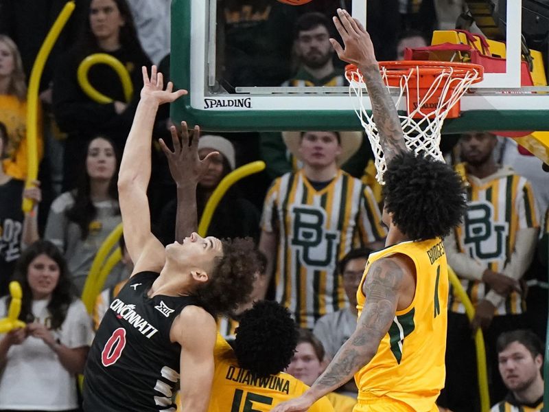 Jan 13, 2024; Waco, Texas, USA; Cincinnati Bearcats guard Dan Skillings Jr. (0) throws the ball up over Baylor Bears forward Jalen Bridges (11) during the second half at Paul and Alejandra Foster Pavilion. Mandatory Credit: Raymond Carlin III-USA TODAY Sports