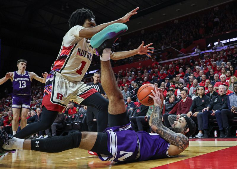 Feb 15, 2024; Piscataway, New Jersey, USA; Northwestern Wildcats guard Boo Buie (0) passes the ball against Rutgers Scarlet Knights guard Jamichael Davis (1) during the first half at Jersey Mike's Arena. Mandatory Credit: Vincent Carchietta-USA TODAY Sports