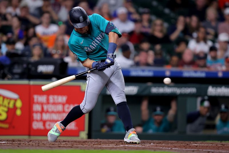 May 5, 2024; Houston, Texas, USA; Seattle Mariners shortstop Dylan Moore (25) hits a single against the Houston Astros during the second inning at Minute Maid Park. Mandatory Credit: Erik Williams-USA TODAY Sports