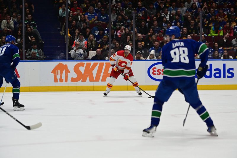 Mar 23, 2024; Vancouver, British Columbia, CAN; Calgary Flames forward Nazem Kadri (91) controls the puck against the Vancouver Canucks during the second period at Rogers Arena. Mandatory Credit: Simon Fearn-USA TODAY Sports