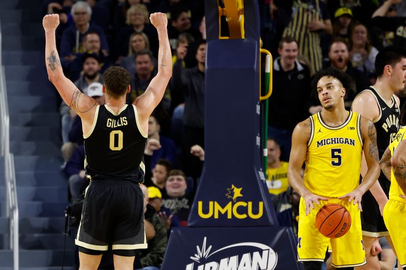 Feb 25, 2024; Ann Arbor, Michigan, USA;  Purdue Boilermakers forward Mason Gillis (0) celebrates in the first half as Michigan Wolverines forward Terrance Williams II (5) reacts at Crisler Center. Mandatory Credit: Rick Osentoski-USA TODAY Sports