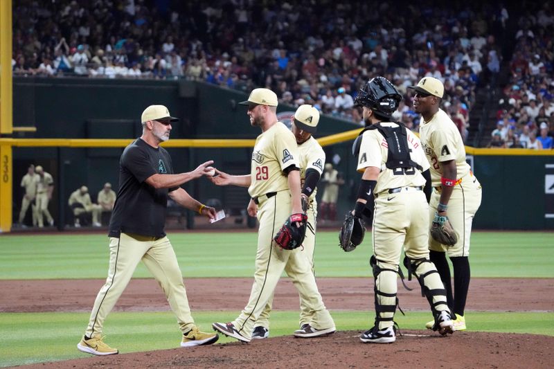 Aug 31, 2024; Phoenix, Arizona, USA; Arizona Diamondbacks manager Torey Lovullo (17) removes Arizona Diamondbacks pitcher Merrill Kelly (29) from the game against the Los Angeles Dodgers during the sixth inning at Chase Field. Mandatory Credit: Joe Camporeale-USA TODAY Sports