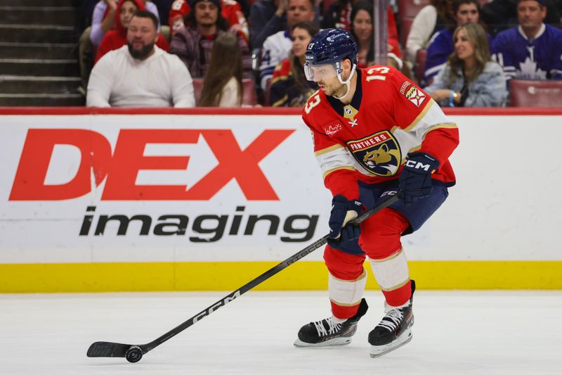 Apr 16, 2024; Sunrise, Florida, USA; Florida Panthers center Sam Reinhart (13) moves the puck against the Toronto Maple Leafs during the first period at Amerant Bank Arena. Mandatory Credit: Sam Navarro-USA TODAY Sports