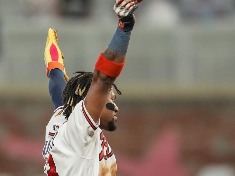 Sep 27, 2023; Cumberland, Georgia, USA; Atlanta Braves right fielder Ronald Acuna Jr. (13) reacts after stealing his 70th base of the season against the Chicago Cubs during the tenth inning at Truist Park. Mandatory Credit: Dale Zanine-USA TODAY Sports