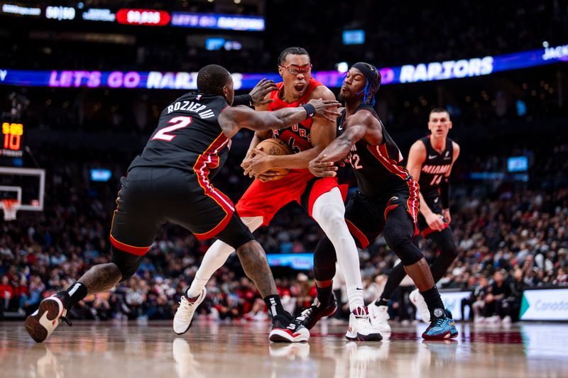 TORONTO, ON - DECEMBER 1: Scottie Barnes #4 of the Toronto Raptors drives to the basket against Terry Rozier #2 and Jimmy Butler #22 of the Miami Heat at Scotiabank Arena on December 1, 2024 in Toronto, Ontario, Canada. NOTE TO USER: User expressly acknowledges and agrees that, by downloading and/or using this Photograph, user is consenting to the terms and conditions of the Getty Images License Agreement. (Photo by Andrew Lahodynskyj/Getty Images)