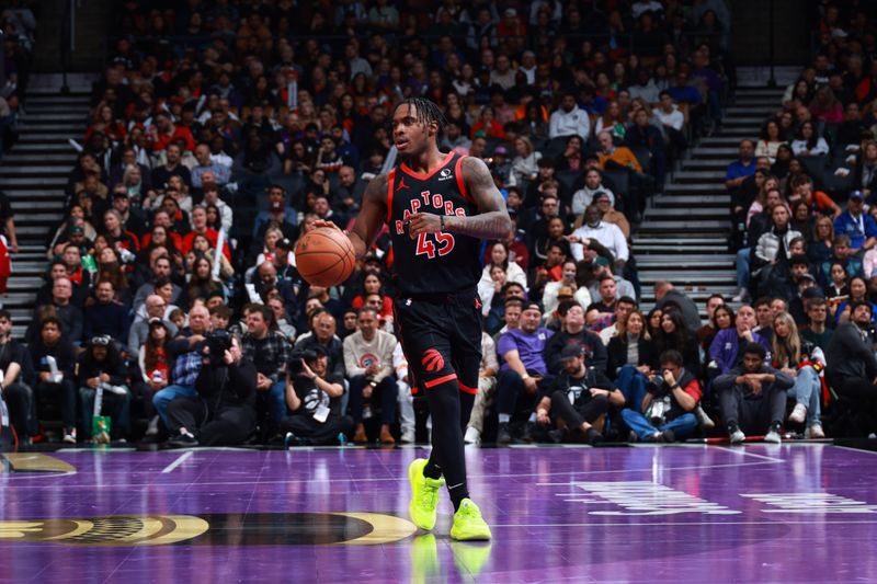 TORONTO, CANADA - NOVEMBER 15: Davion Mitchell #45 of the Toronto Raptors dribbles the ball during the game against the Detroit Pistons during the Emirates NBA Cup game on November 15, 2024 at the Scotiabank Arena in Toronto, Ontario, Canada.  NOTE TO USER: User expressly acknowledges and agrees that, by downloading and or using this Photograph, user is consenting to the terms and conditions of the Getty Images License Agreement.  Mandatory Copyright Notice: Copyright 2024 NBAE (Photo by Vaughn Ridley/NBAE via Getty Images)