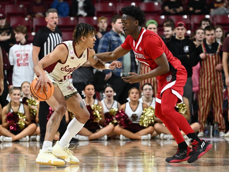 Feb 11, 2023; Chestnut Hill, Massachusetts, USA; Boston College Eagles guard Makai Ashton-Langford (11) controls the ball against North Carolina State Wolfpack guard Jarkel Joiner (1) during the first half at the Conte Forum. Mandatory Credit: Brian Fluharty-USA TODAY Sports