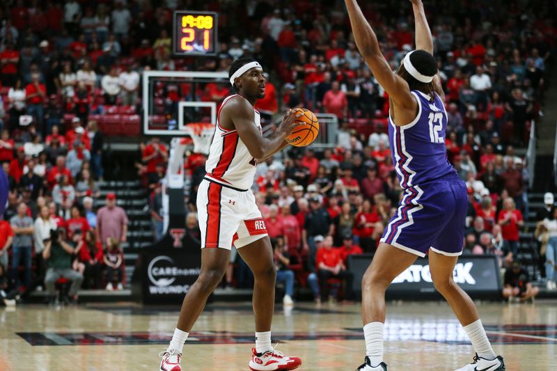 Feb 20, 2024; Lubbock, Texas, USA;  Texas Tech Red Raiders forward Robert Jennings (25) looks to pass the ball against TCU Horned Frogs forward Xavier Cork (12) in the first half at United Supermarkets Arena. Mandatory Credit: Michael C. Johnson-USA TODAY Sports