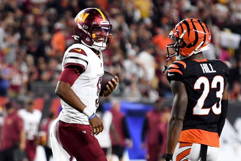 Washington Commanders quarterback Jayden Daniels (5) celebrates throwing a pass for a touchdown in the second half during an NFL football game against the Cincinnati Bengals on Monday, Sept. 23, 2024, in Cincinnati. (AP Photo/Emilee Chinn)