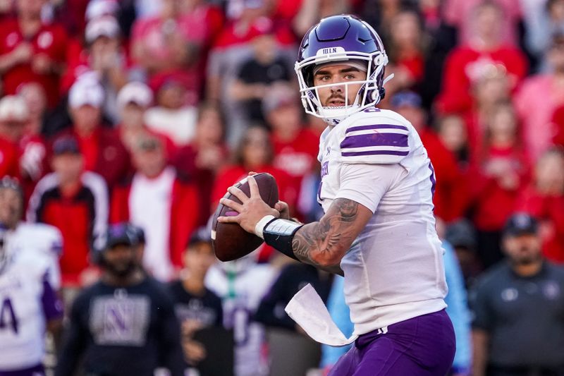 Oct 21, 2023; Lincoln, Nebraska, USA; Northwestern Wildcats quarterback Brendan Sullivan (6) looks for a pass against the Nebraska Cornhuskers during the fourth quarter at Memorial Stadium. Mandatory Credit: Dylan Widger-USA TODAY Sports