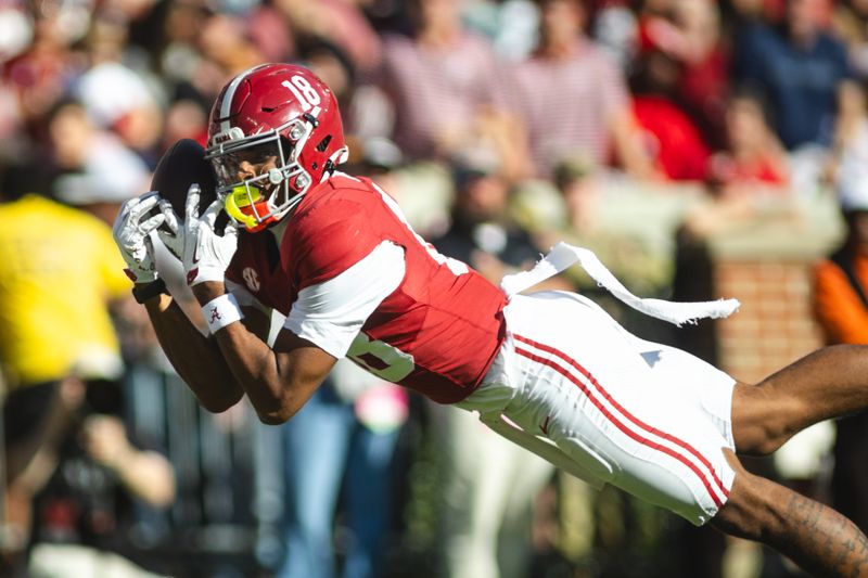 Nov 16, 2024; Tuscaloosa, Alabama, USA; Alabama Crimson Tide wide receiver Caleb Odom (18) dives in an attempt to complete a pass agains the Mercer Bears during the first quarter at Bryant-Denny Stadium. Mandatory Credit: Will McLelland-Imagn Images