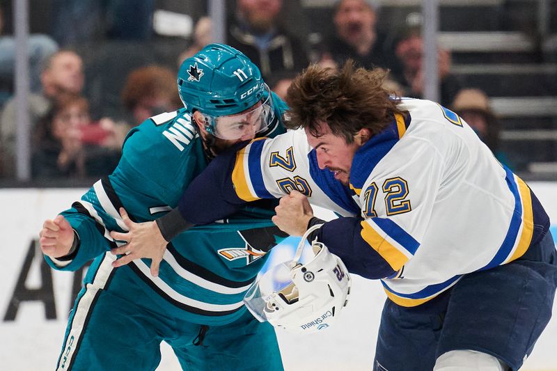 Apr 6, 2024; San Jose, California, USA; San Jose Sharks center Luke Kunin (11) fights against St. Louis Blues defenseman Justin Faulk (72) during the second period at SAP Center at San Jose. Mandatory Credit: Robert Edwards-USA TODAY Sports