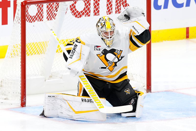 Oct 20, 2024; Winnipeg, Manitoba, CAN; Pittsburgh Penguins goaltender Alex Nedeljkovic (39) makes a glove save in the third period against the Winnipeg Jets at Canada Life Centre. Mandatory Credit: James Carey Lauder-Imagn Images