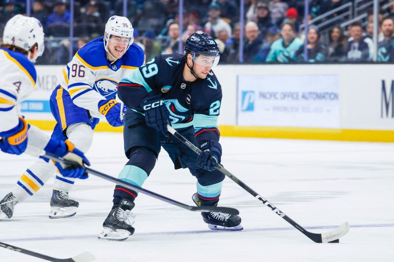Jan 20, 2025; Seattle, Washington, USA; Seattle Kraken defenseman Vince Dunn (29) skates with the puck ahead of Buffalo Sabres right wing Nicolas Aube-Kubel (96) during the first period at Climate Pledge Arena. Mandatory Credit: Joe Nicholson-Imagn Images