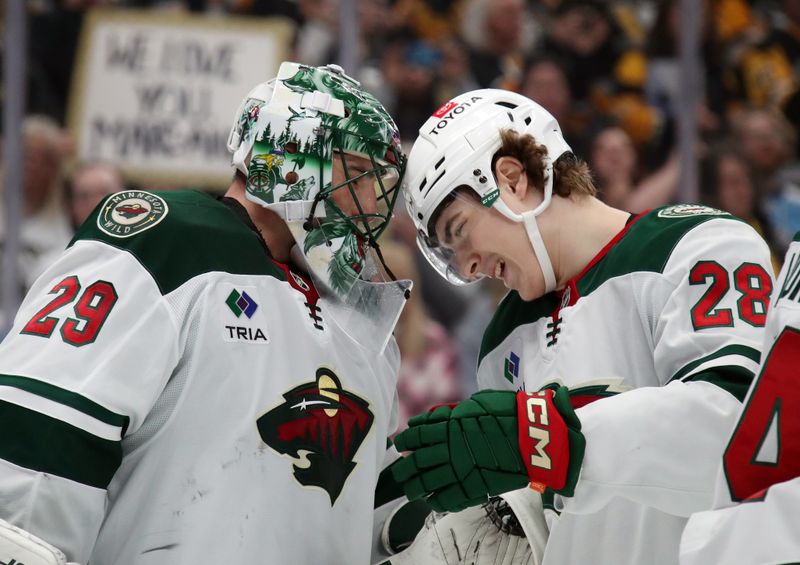 Oct 29, 2024; Pittsburgh, Pennsylvania, USA; Minnesota Wild goaltender Marc-Andre Fleury (29) and left wing Liam Ohgren (28) celebrate after defeating the Pittsburgh Penguins at PPG Paints Arena. Mandatory Credit: Charles LeClaire-Imagn Images