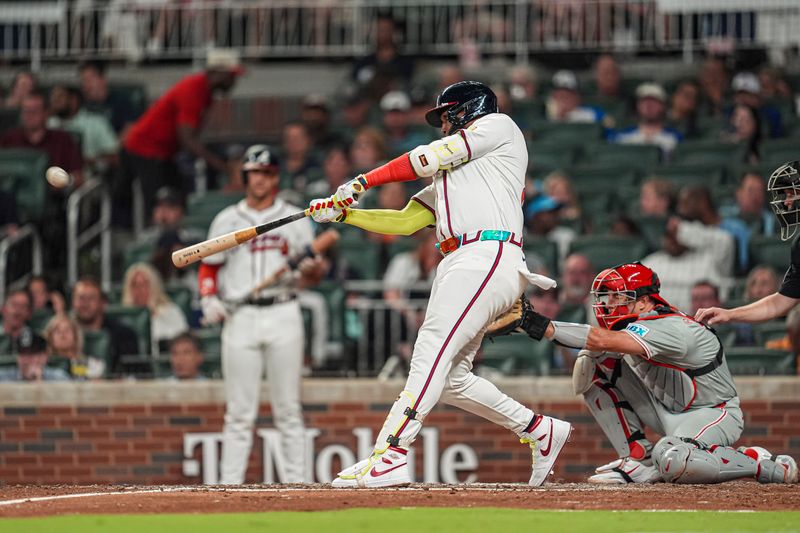 Aug 20, 2024; Cumberland, Georgia, USA; Atlanta Braves designated hitter Marcell Ozuna (20) hits a home run against the Philadelphia Phillies during the sixth inning at Truist Park. Mandatory Credit: Dale Zanine-USA TODAY Sports