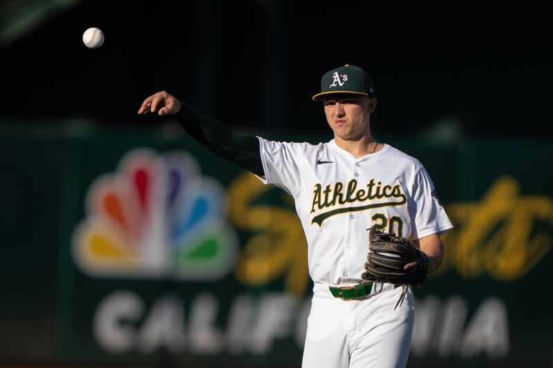 Jul 5, 2024; Oakland, California, USA; Oakland Athletics second base Zack Gelof (20) warms up before the start of the first inning against the Baltimore Orioles at Oakland-Alameda County Coliseum. Mandatory Credit: Stan Szeto-USA TODAY Sports