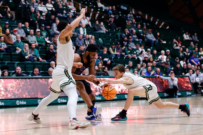 Feb 15, 2023; Fort Collins, Colorado, USA; Boise State Broncos forward Naje Smith (23) controls the ball against Colorado State Rams guard John Tonje (1) and guard Baylor Hebb (5) in the first half at Moby Arena. Mandatory Credit: Isaiah J. Downing-USA TODAY Sports