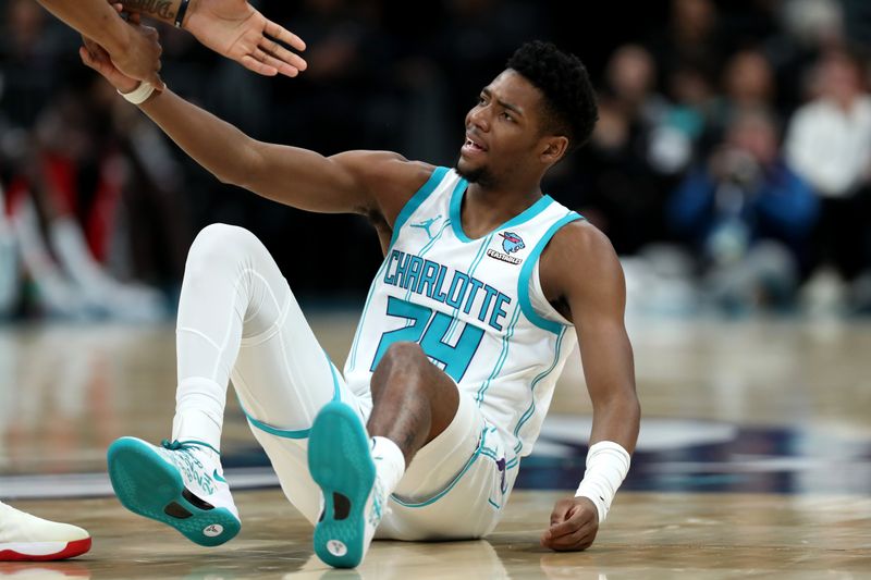 CHARLOTTE, NORTH CAROLINA - APRIL 03: Brandon Miller #24 of the Charlotte Hornets is helped up from the floor during the first half against the Portland Trail Blazers at Spectrum Center on April 03, 2024 in Charlotte, North Carolina. NOTE TO USER: User expressly acknowledges and agrees that, by downloading and or using this photograph, User is consenting to the terms and conditions of the Getty Images License Agreement. (Photo by David Jensen/Getty Images)