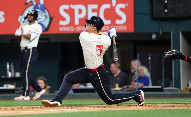 Aug 2, 2024; Arlington, Texas, USA; Texas Rangers shortstop Corey Seager (5) hits a home run during the third inning against the Boston Red Sox at Globe Life Field. Mandatory Credit: Kevin Jairaj-USA TODAY Sports