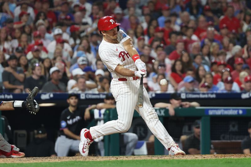 Aug 14, 2024; Philadelphia, Pennsylvania, USA; Philadelphia Phillies catcher J.T. Realmuto (10) hits a two RBI double during the seventh inning against the Miami Marlins at Citizens Bank Park. Mandatory Credit: Bill Streicher-USA TODAY Sports