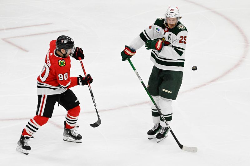 Apr 7, 2024; Chicago, Illinois, USA;  Chicago Blackhawks center Tyler Johnson (90) passes the puck away from Minnesota Wild defenseman Jonas Brodin (25) during the second period at United Center. Mandatory Credit: Matt Marton-USA TODAY Sports