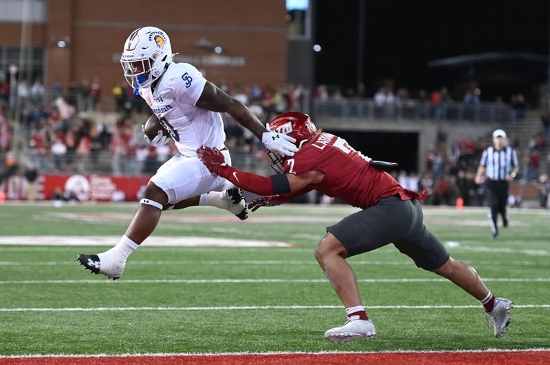 Sep 20, 2024; Pullman, Washington, USA; San Jose State Spartans running back Floyd Chalk IV (0) jumps into the end zone against Washington State Cougars defensive back Jackson Lataimua (2) in the second half at Gesa Field at Martin Stadium. Washington State Cougars won 54-52 in double overtime. Mandatory Credit: James Snook-Imagn Images