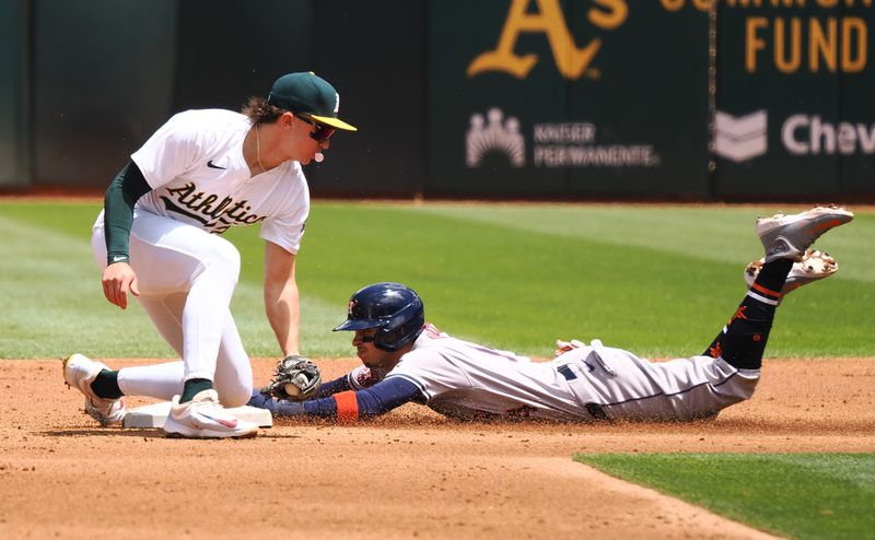 May 25, 2024; Oakland, California, USA; Houston Astros second baseman Mauricio Dubon (14) steals second base against Oakland Athletics second baseman Zack Gelof (20) during the third inning at Oakland-Alameda County Coliseum. Mandatory Credit: Kelley L Cox-USA TODAY Sports