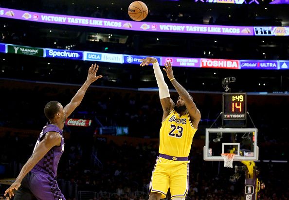 Los Angeles, CA -  Lakers forward LeBron James shoots and scores a three-pointer against Kings defender Harrison Barnes in the first half at crypto.com Arena in Los Angeles on Wednesday night, Nov. 15, 2023. (Luis Sinco / Los Angeles Times via Getty Images)