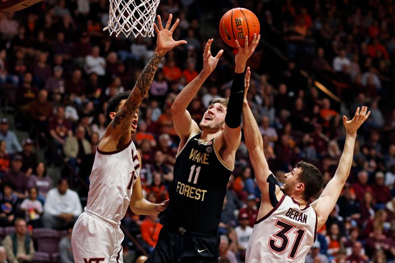 Mar 2, 2024; Blacksburg, Virginia, USA; Wake Forest Demon Deacons forward Andrew Carr (11) shoots the ball against Virginia Tech Hokies forward Robbie Beran (31) and Virginia Tech Hokies center Lynn Kidd (15) during the first half at Cassell Coliseum. Mandatory Credit: Peter Casey-USA TODAY Sports