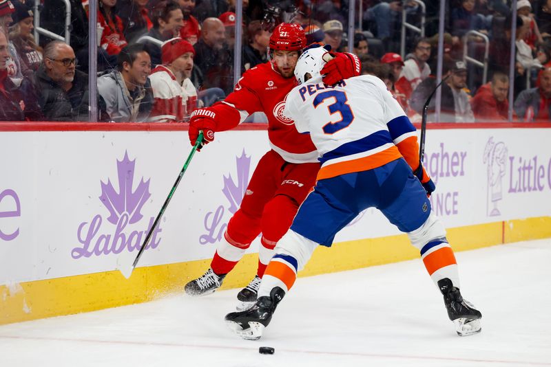 Nov 20, 2025; Detroit, Michigan, USA;  Detroit Red Wings left wing James van Riemsdyk (21) skates with the puck defended by New York Islanders defenseman Adam Pelech (3) in the second period at Little Caesars Arena. Mandatory Credit: Rick Osentoski-Imagn Images
