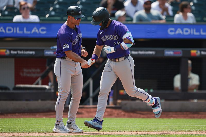 Jul 14, 2024; New York City, New York, USA;  Colorado Rockies shortstop Ezequiel Tovar (14) celebrates his two run home run during the seventh inning with third base coach Warren Schaeffer (34) at Citi Field. Mandatory Credit: Vincent Carchietta-USA TODAY Sports