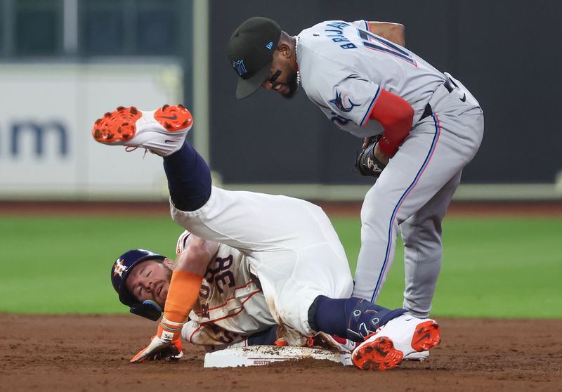 Jul 11, 2024; Houston, Texas, USA; Houston Astros right fielder Trey Cabbage (38) slides safely into second base against Miami Marlins second baseman Vidal Brujan (17) in the second inning at Minute Maid Park. Mandatory Credit: Thomas Shea-USA TODAY Sports