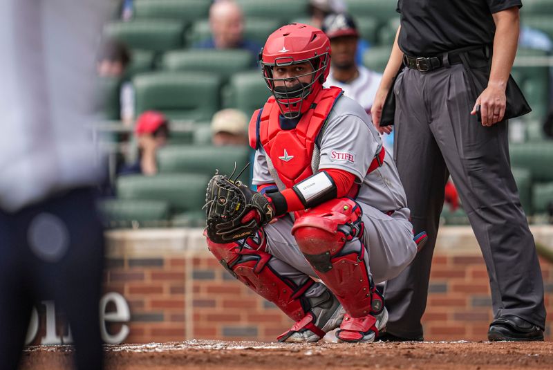 Apr 23, 2025; Cumberland, Georgia, USA; St. Louis Cardinals catcher Yohel Pozo (63) looks into the dugout against the Atlanta Braves during the first inning at Truist Park. Mandatory Credit: Dale Zanine-Imagn Images