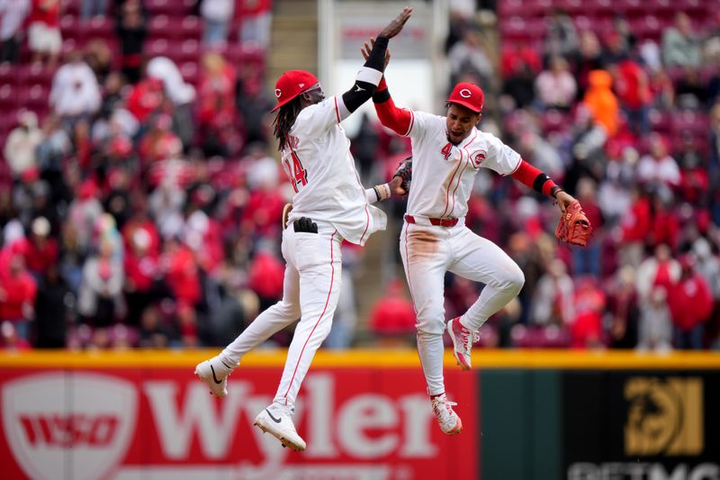 April 21, 2024; Cincinnati, Ohio, USA; Cincinnati Reds shortstop Elly De La Cruz (44) and Cincinnati Reds second base Santiago Espinal (4) celebrate the win at the conclusion of the ninth inning of a baseball game against the Los Angeles Angels at Great American Ball Park. Mandatory Credit: Kareem Elgazzar/USA TODAY Sports via The Cincinnati Enquirer

