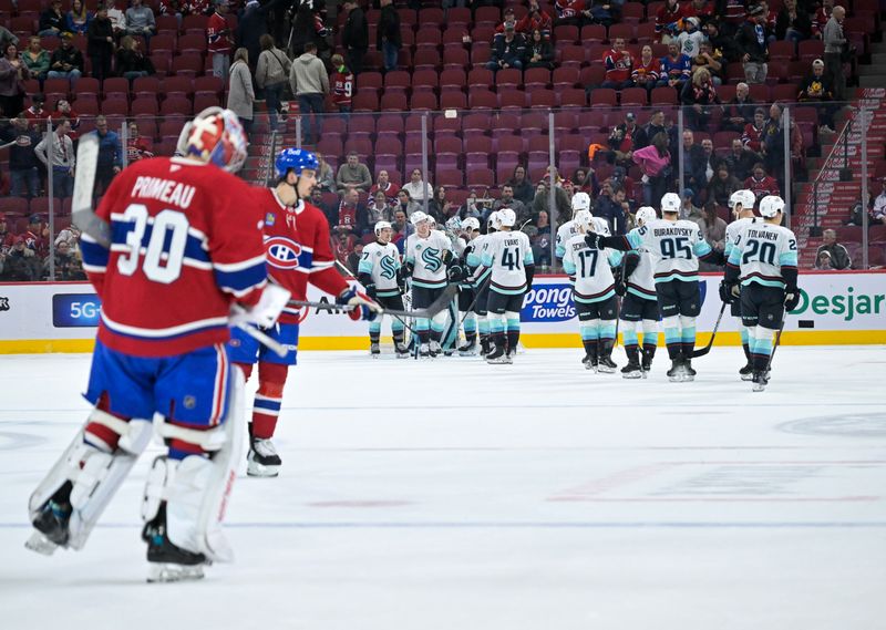 Oct 29, 2024; Montreal, Quebec, CAN; Seattle Kraken players celebrate the win against the Montreal Canadiens at the Bell Centre. Mandatory Credit: Eric Bolte-Imagn Images