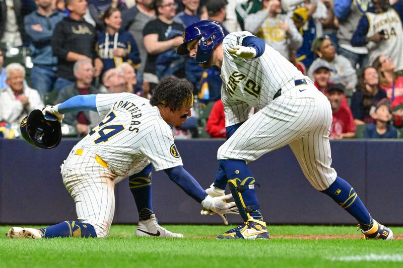 May 11, 2024; Milwaukee, Wisconsin, USA; Milwaukee Brewers first baseman Rhys Hoskins (12) celebrates with catcher William Contreras (24) after hitting a three-run home run against the St. Louis Cardinals in the seventh inning at American Family Field. Mandatory Credit: Benny Sieu-USA TODAY Sports