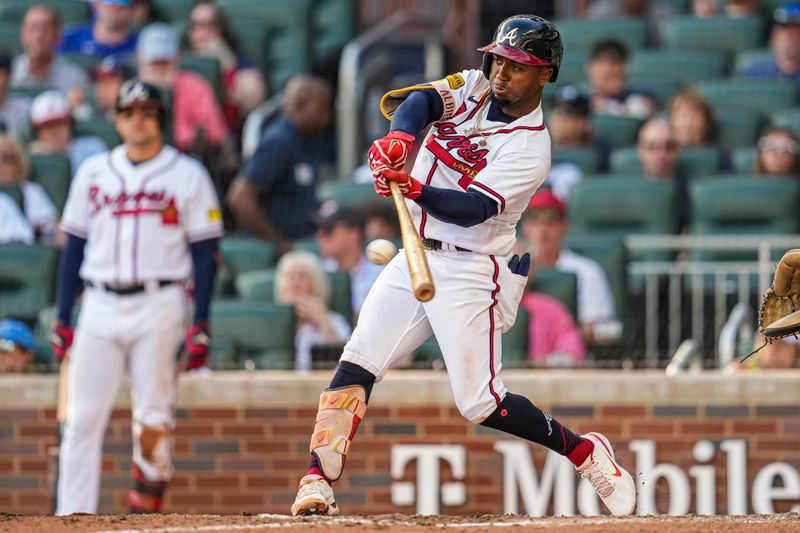 Oct 1, 2023; Cumberland, Georgia, USA; Atlanta Braves second baseman Ozzie Albies (1) singles against the Washington Nationals during the seventh inning at Truist Park. Mandatory Credit: Dale Zanine-USA TODAY Sports