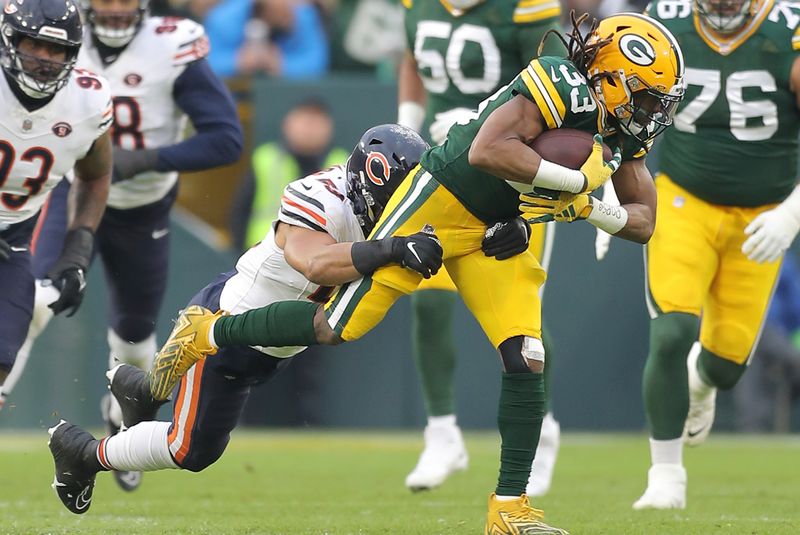 Chicago Bears linebacker T.J. Edwards (53) tackles Green Bay Packers running back Aaron Jones (33) during an NFL football game, Sunday, Jan. 07, 2024, in Green Bay. (AP Photo/Melissa Tamez)