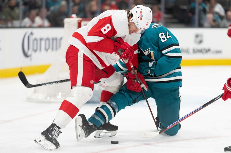 Jan 2, 2024; San Jose, California, USA; Detroit Red Wings defenseman Ben Chiarot (8) and San Jose Sharks defenseman Jan Rutta (84) fight for control of the puck during the second period at SAP Center at San Jose. Mandatory Credit: Stan Szeto-USA TODAY Sports