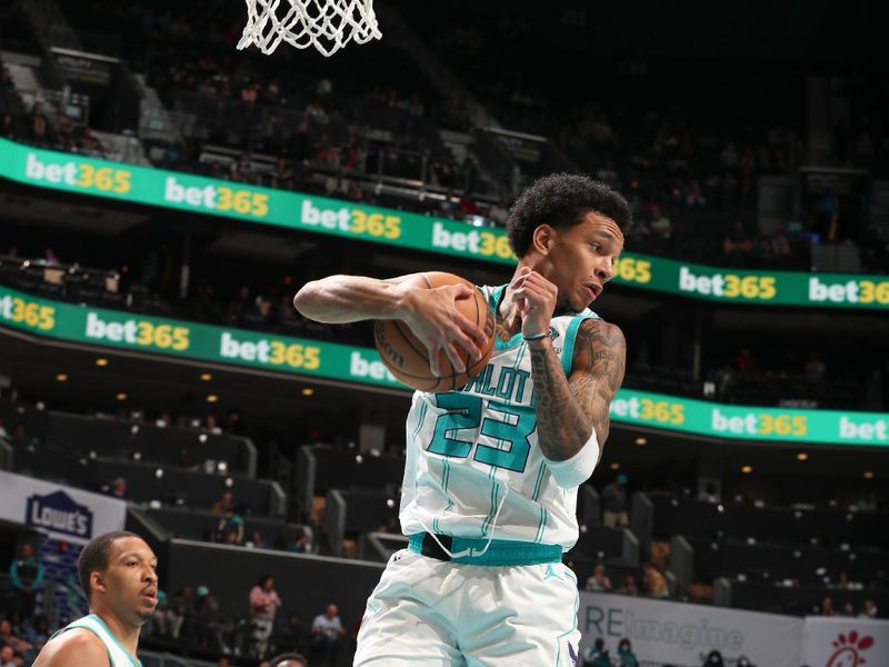 CHARLOTTE, NC - APRIL 3: Tre Mann #23 of the  Charlotte Hornets grabs the rebound during the game on April 3, 2024 at Spectrum Center in Charlotte, North Carolina. NOTE TO USER: User expressly acknowledges and agrees that, by downloading and or using this photograph, User is consenting to the terms and conditions of the Getty Images License Agreement. Mandatory Copyright Notice: Copyright 2024 NBAE (Photo by Kent Smith/NBAE via Getty Images)