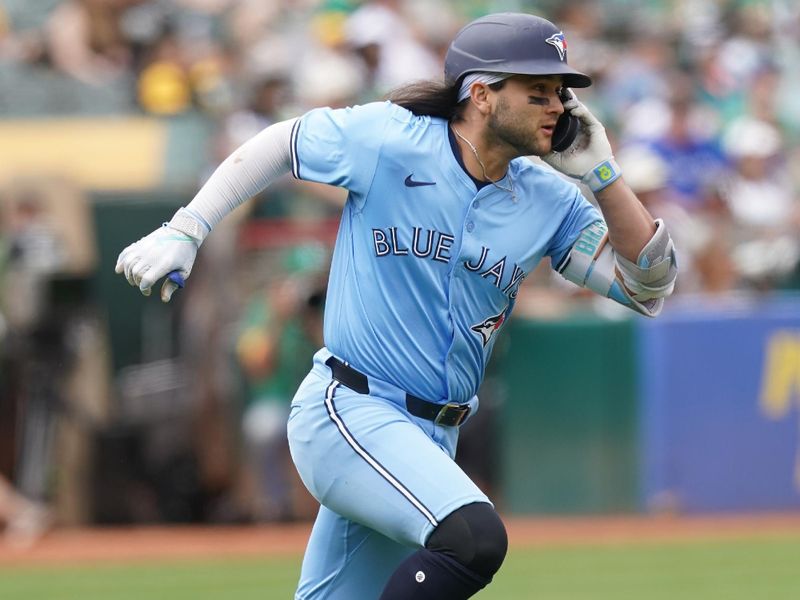 Jun 8, 2024; Oakland, California, USA; Toronto Blue Jays shortstop Bo Bichette (11) holds onto his helmet after hitting a fly ball against the Oakland Athletics in the sixth inning at Oakland-Alameda County Coliseum. Mandatory Credit: Cary Edmondson-USA TODAY Sports