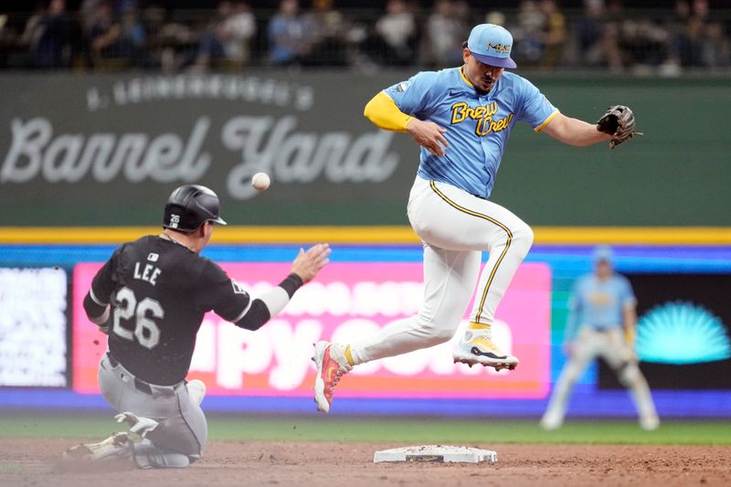May 31, 2024; Milwaukee, Wisconsin, USA;  Chicago White Sox catcher Korey Lee (26) steals second base as the ball gets away from Milwaukee Brewers shortstop Willy Adames (27) during the fifth inning at American Family Field. Mandatory Credit: Jeff Hanisch-USA TODAY Sports