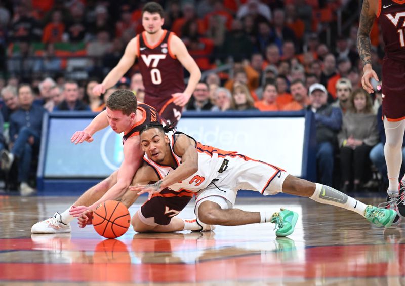 Feb 27, 2024; Syracuse, New York, USA; Syracuse Orange guard Judah Mintz (3) battles Virginia Tech Hokies guard Sean Pedulla for a loose ball in the first half at the JMA Wireless Dome. Mandatory Credit: Mark Konezny-USA TODAY Sports