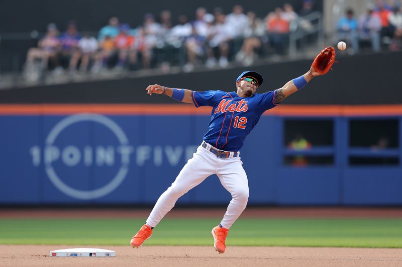 Jul 1, 2023; New York City, New York, USA; New York Mets shortstop Francisco Lindor (12) can't catch a throw by first baseman Pete Alonso (not pictured) on a ground ball by San Francisco Giants catcher Patrick Bailey (not pictured) during the seventh inning at Citi Field. Mandatory Credit: Brad Penner-USA TODAY Sports