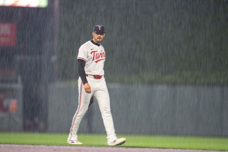 May 19, 2025; Minneapolis, Minnesota, USA; Minnesota Twins left fielder Trevor Larnach (9) walks off the field in the fourth inning during the second rain delay of the game against the Cleveland Guardians at Target Field. Mandatory Credit: Jesse Johnson-Imagn Images
