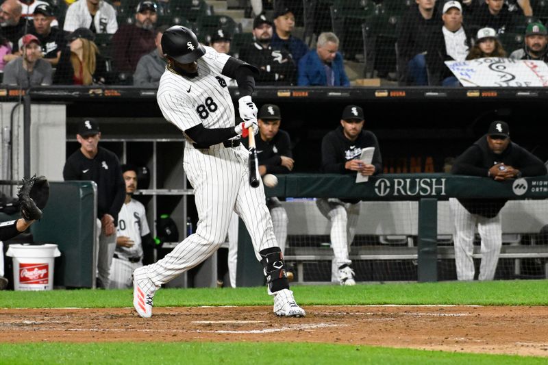 Sep 25, 2024; Chicago, Illinois, USA;  Chicago White Sox outfielder Luis Robert Jr. (88) hits a double against the Los Angeles Angels during the seventh inning at Guaranteed Rate Field. Mandatory Credit: Matt Marton-Imagn Images