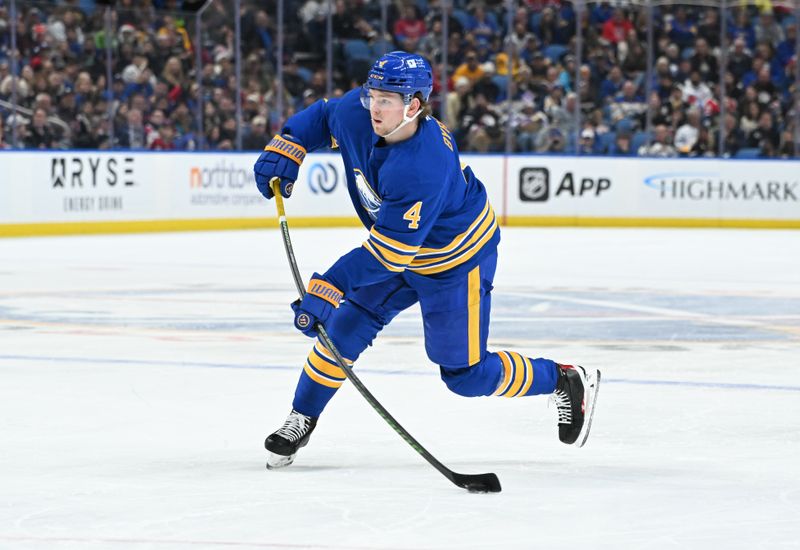 Nov 11, 2024; Buffalo, New York, USA; Buffalo Sabres defenseman Bowen Byram (4) shoots the puck in the second period against the Montreal Canadiens at KeyBank Center. Mandatory Credit: Mark Konezny-Imagn Images