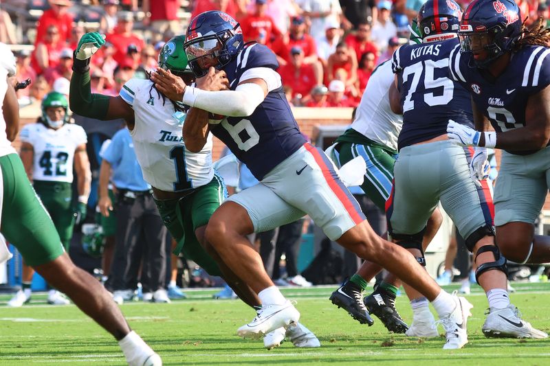 Sep 20, 2025; Oxford, Mississippi, USA; Mississippi Rebels quarterback Trinidad Chambliss (6) runs the ball as Tulane Green Wave defensive back Jack Tchienchou (1) makes the tackle during the third quarter at Vaught-Hemingway Stadium. Mandatory Credit: Petre Thomas-Imagn Images