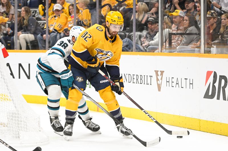 Oct 21, 2023; Nashville, Tennessee, USA; Nashville Predators center Tommy Novak (82) skates as San Jose Sharks defenseman Mario Ferraro (38) defends during the third period at Bridgestone Arena. Mandatory Credit: Steve Roberts-USA TODAY Sports